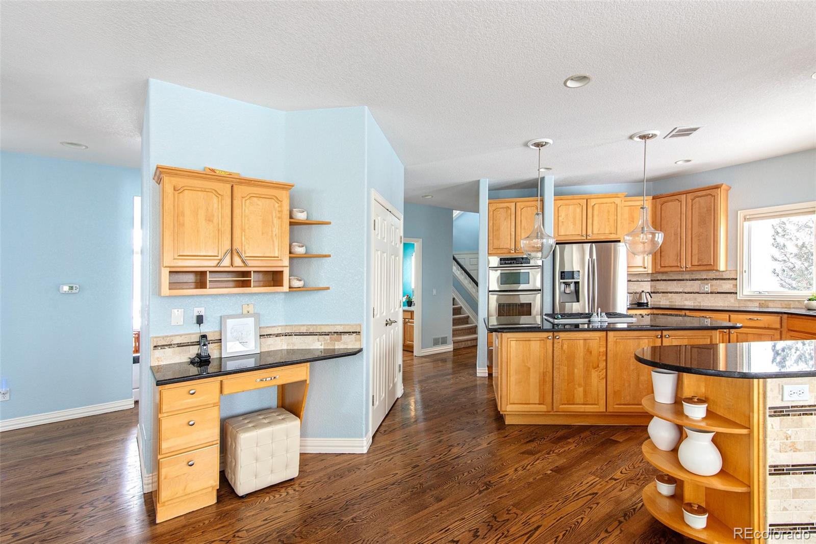 535 Sawtooth Point Lafayette, CO 80026 - Photo 8 of 40 a kitchen with stainless steel appliances wooden floor and large window