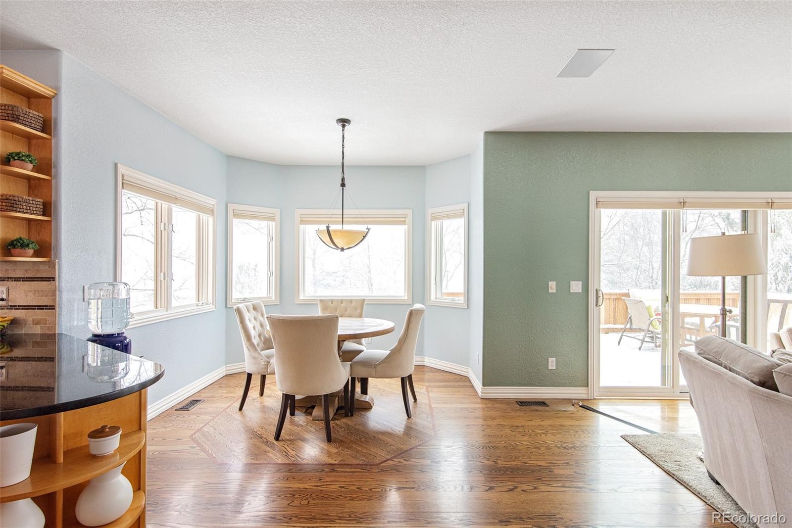 535 Sawtooth Point Lafayette, CO 80026 - Photo 10 of 40 a view of a dining room with furniture window and wooden floor