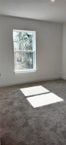 a front view of a house with lots of trees