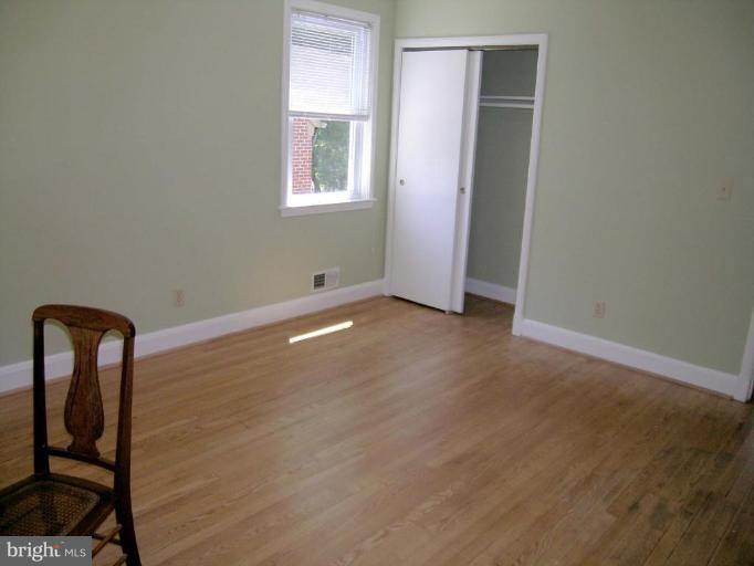 731 Overbrook Road Baltimore, MD 21212 - Photo 11 of 20 an empty room with windows and wooden floor