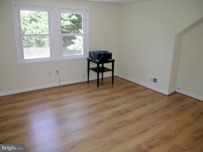 731 Overbrook Road Baltimore, MD 21212 - Photo 14 of 20 a view of an empty room with wooden floor and a window