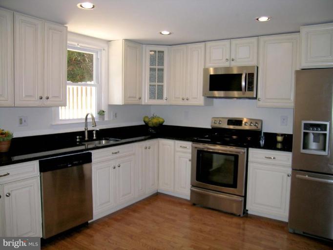 731 Overbrook Road Baltimore, MD 21212 - Photo 3 of 20 a kitchen with granite countertop white cabinets stainless steel appliances and a sink