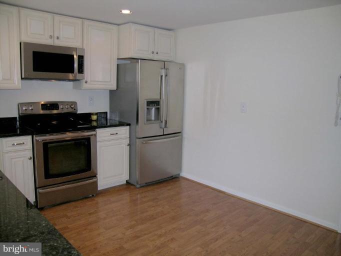 731 Overbrook Road Baltimore, MD 21212 - Photo 8 of 20 a kitchen with a stove a microwave and refrigerator