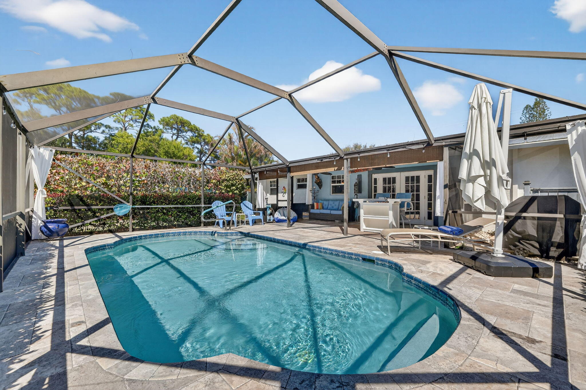 1252 East Madison Avenue Stuart, FL 34996 - Photo 1 of 43 a view of a swimming pool with a patio