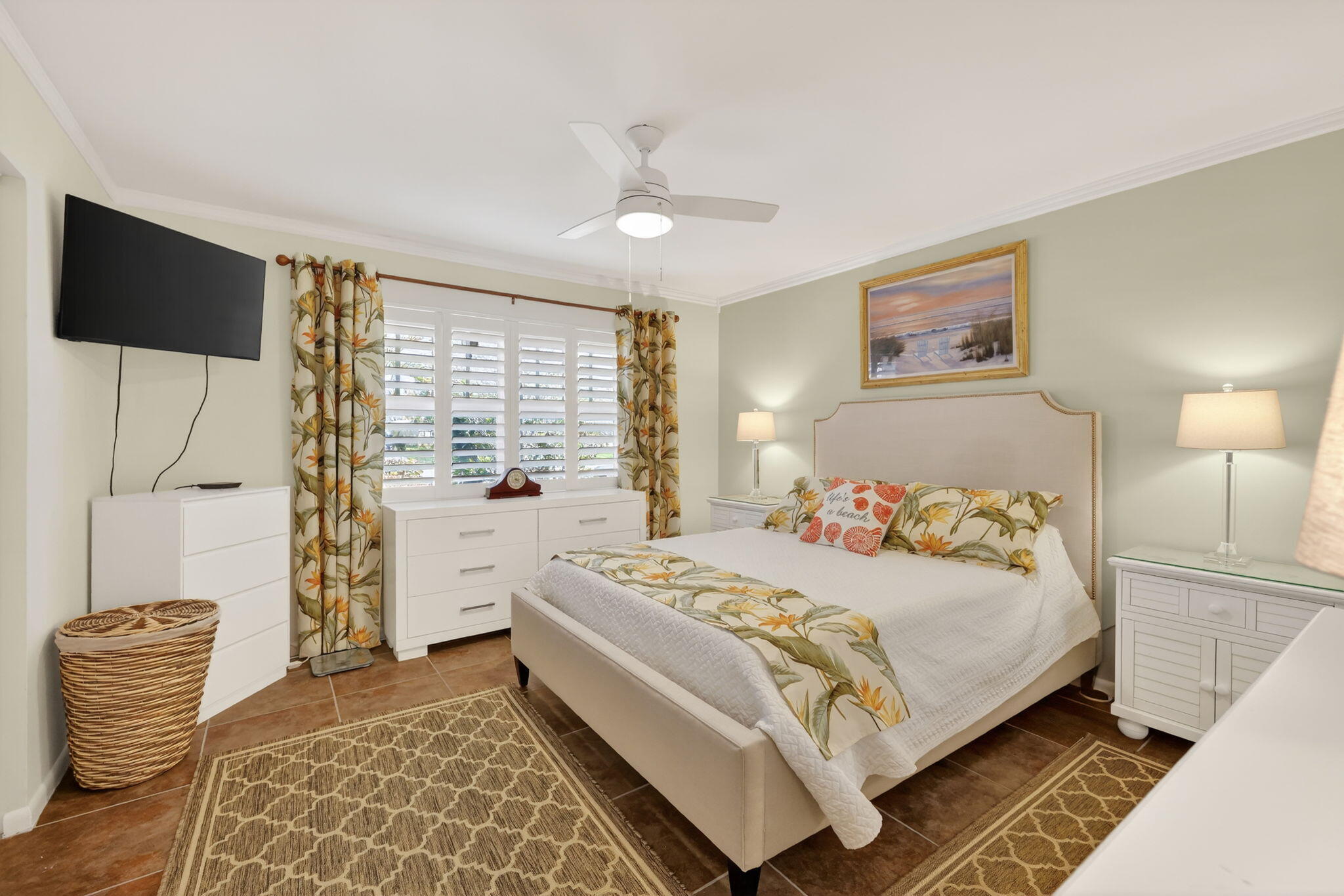 1252 East Madison Avenue Stuart, FL 34996 - Photo 12 of 43 a bedroom with a bed and a chandelier