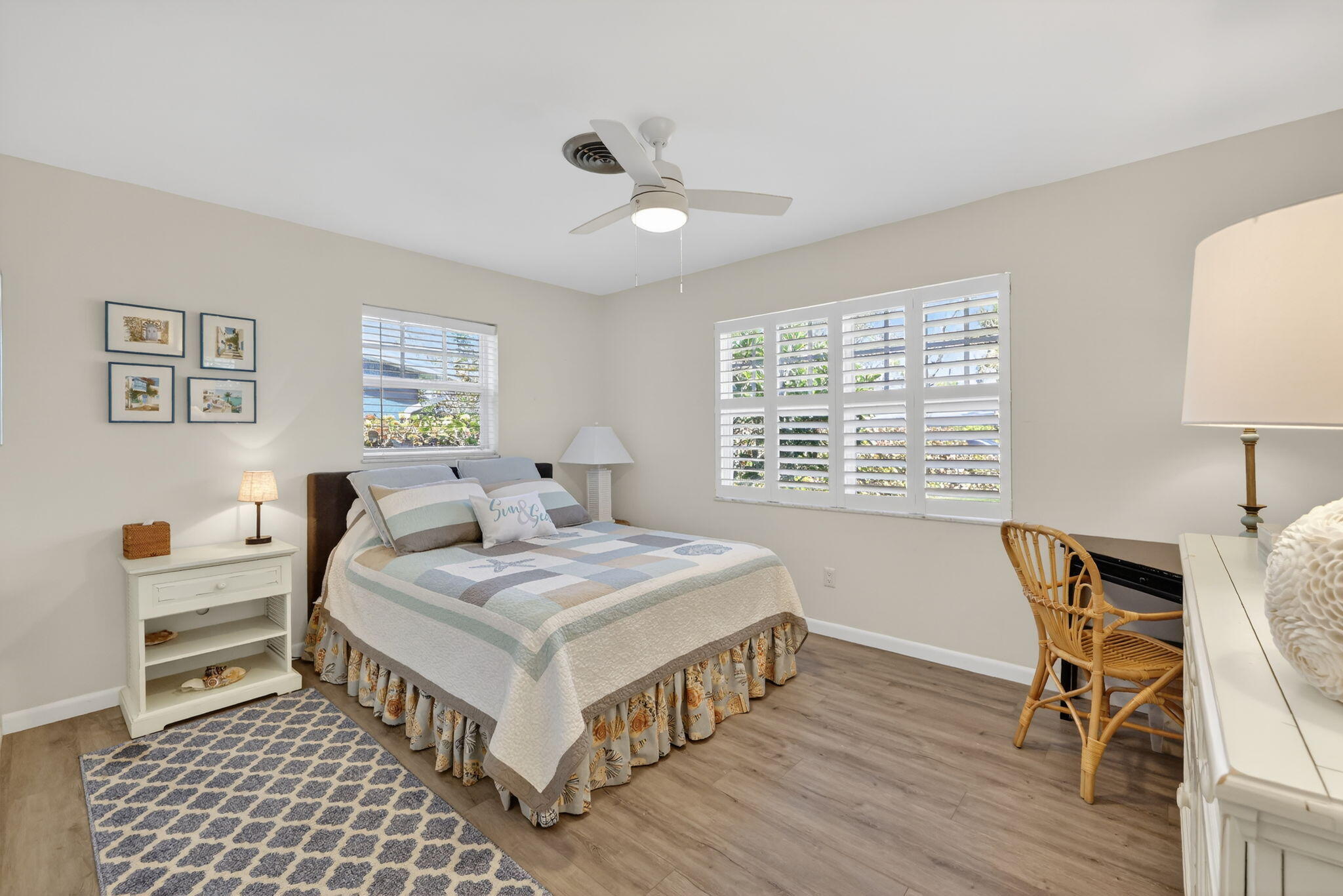 1252 East Madison Avenue Stuart, FL 34996 - Photo 13 of 43 a bedroom that has a bed and a table in it