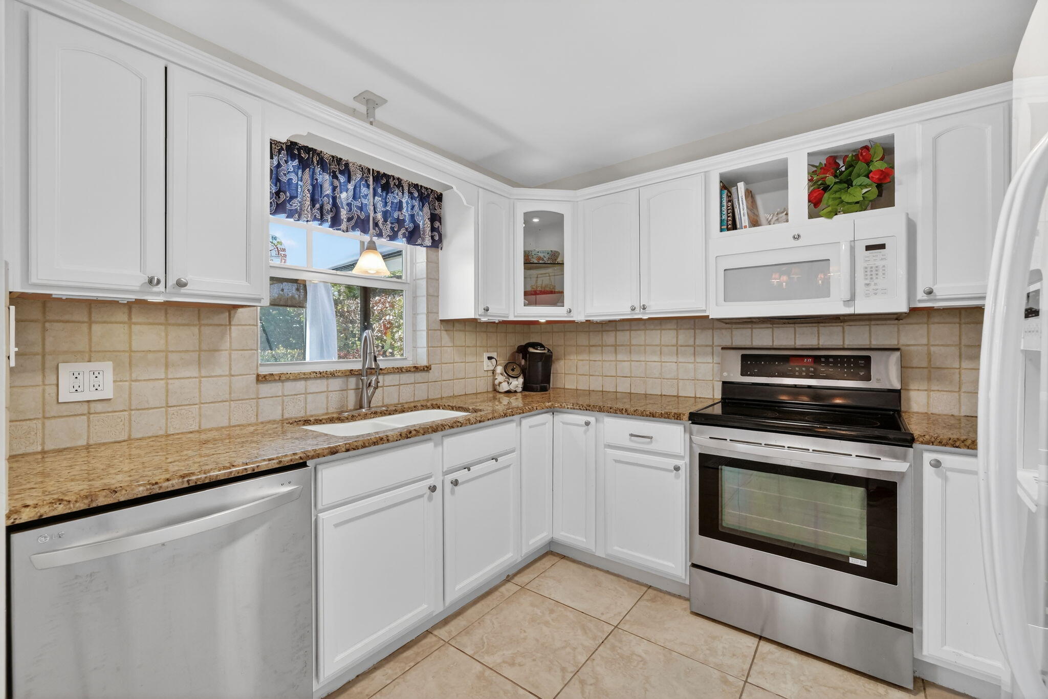 1252 East Madison Avenue Stuart, FL 34996 - Photo 14 of 43 a kitchen with cabinets appliances and a window
