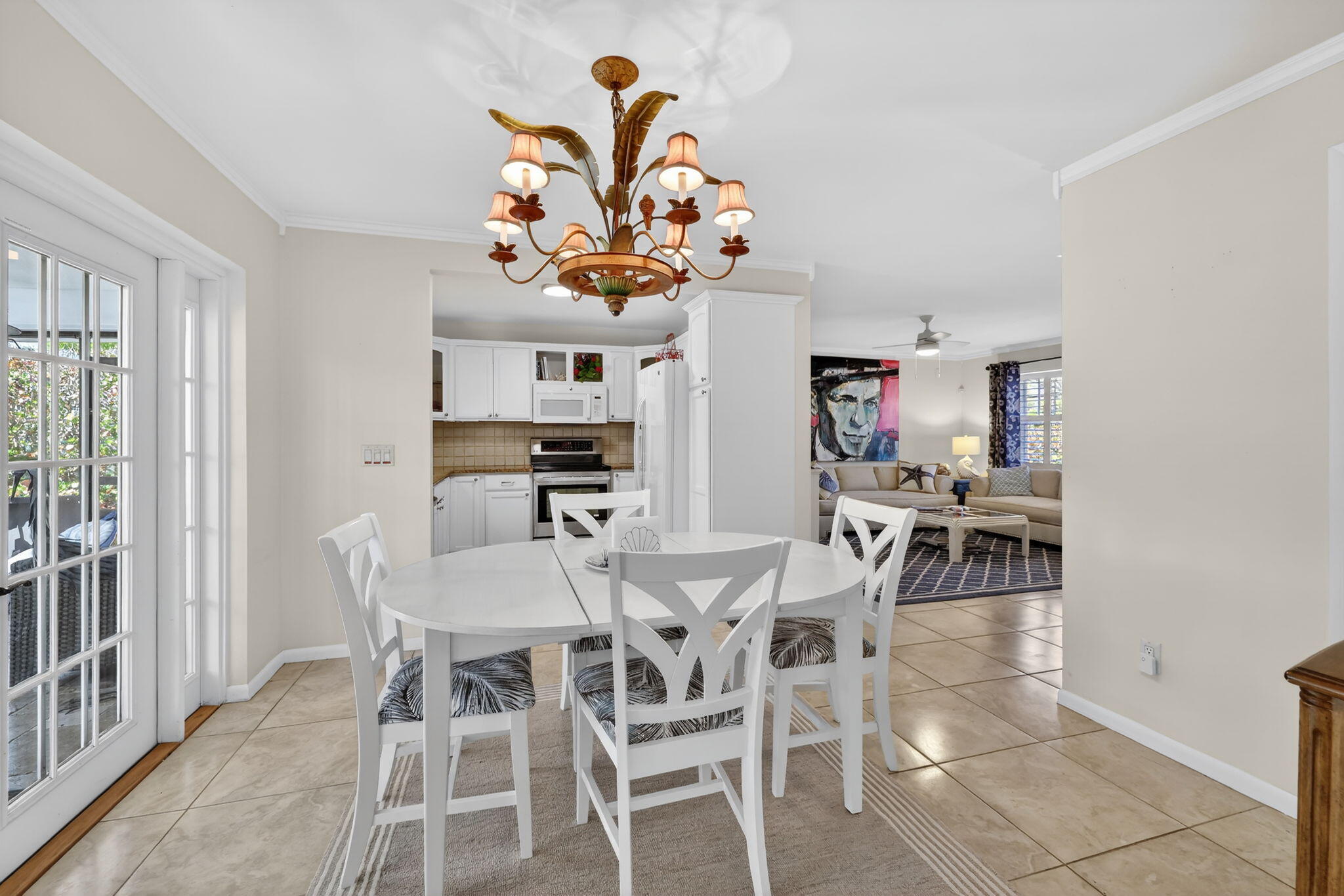 1252 East Madison Avenue Stuart, FL 34996 - Photo 17 of 43 a view of a dining room with furniture and a potted plant