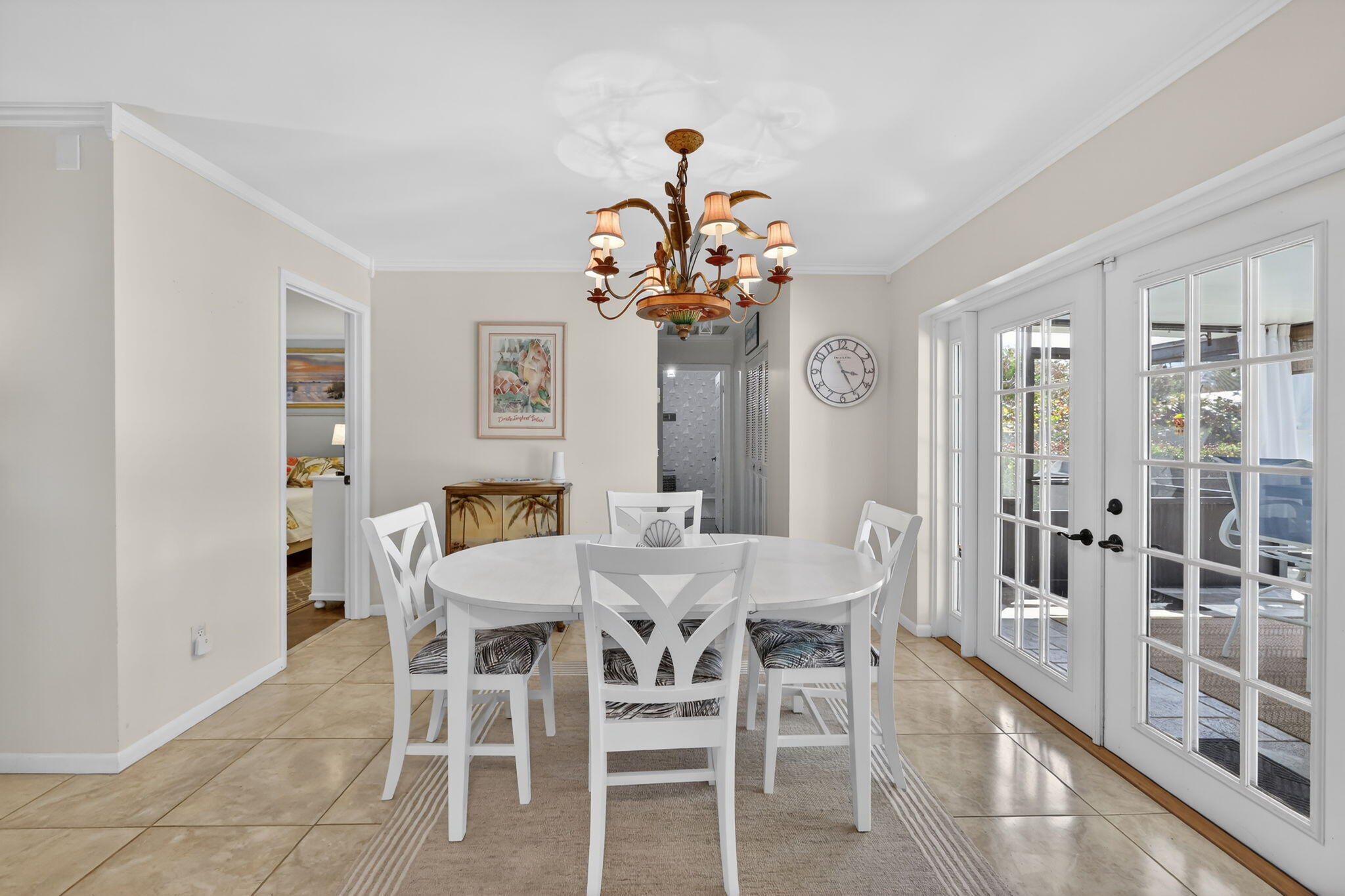 1252 East Madison Avenue Stuart, FL 34996 - Photo 18 of 43 a view of a dining room with furniture and a chandelier