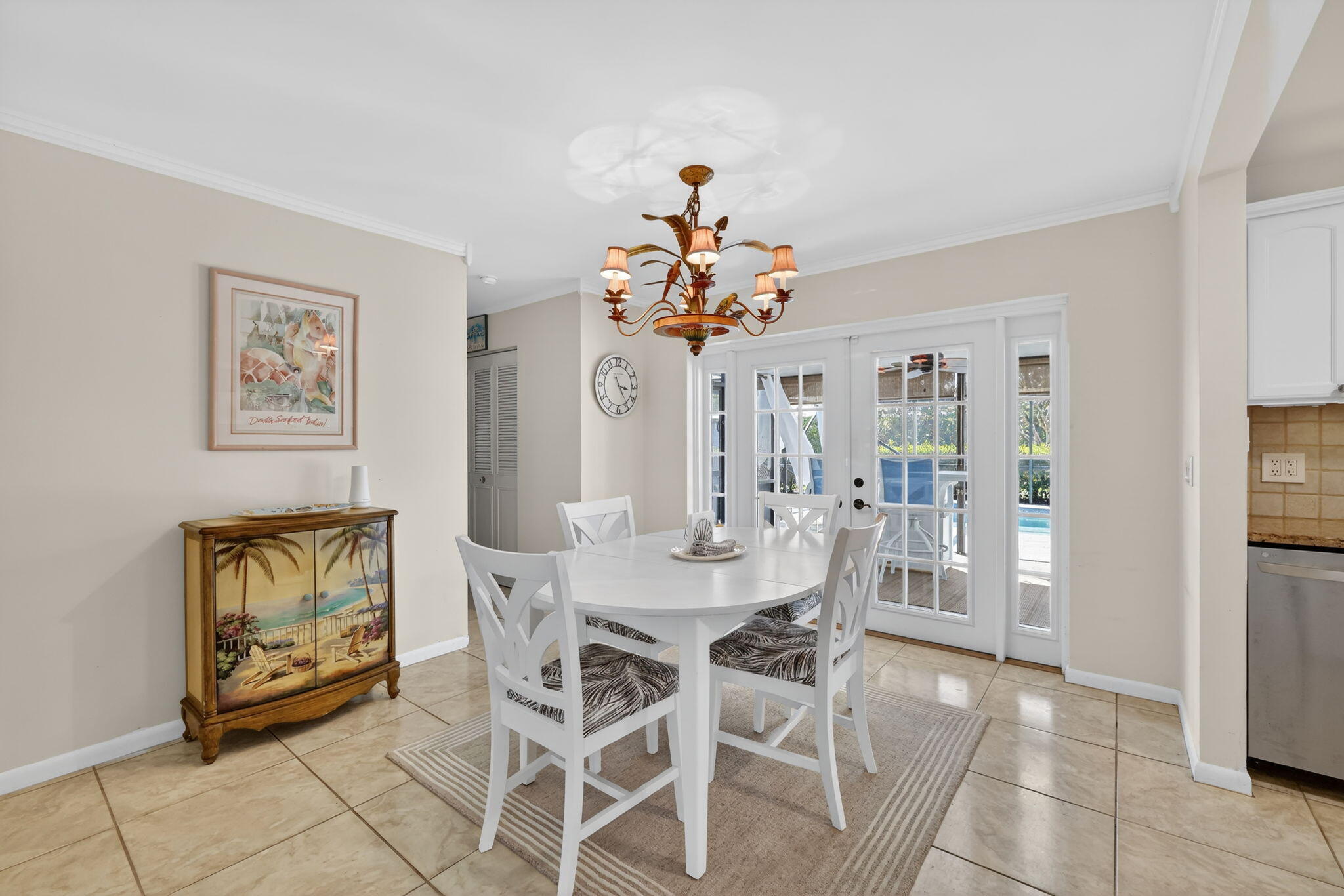 1252 East Madison Avenue Stuart, FL 34996 - Photo 19 of 43 a view of a dining room with furniture and a chandelier