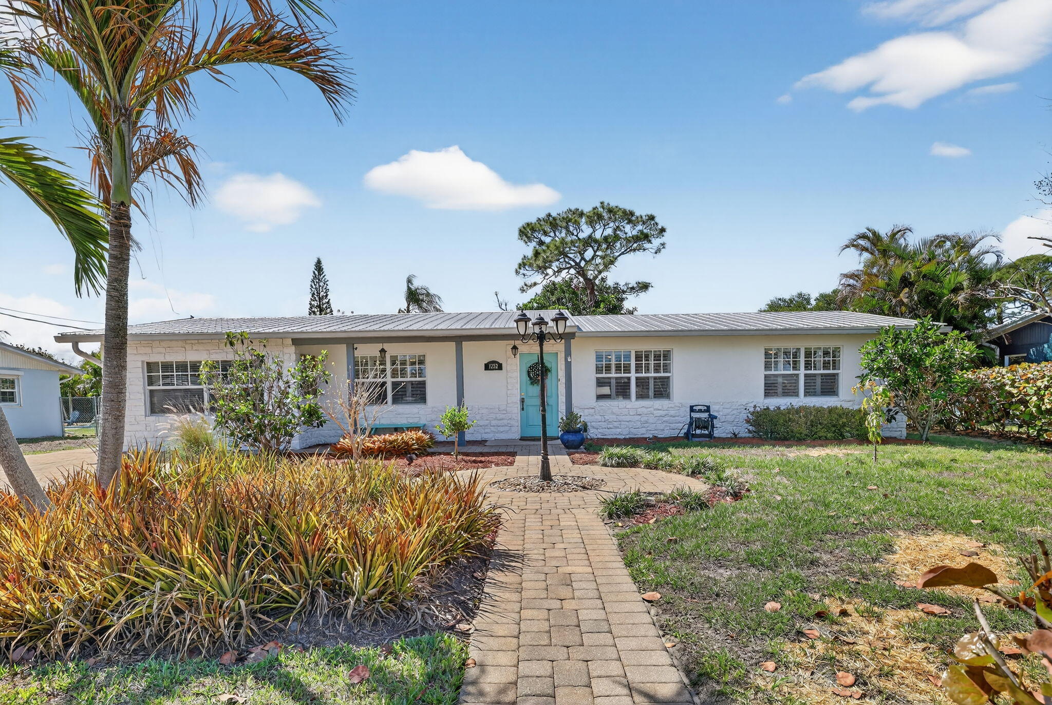 1252 East Madison Avenue Stuart, FL 34996 - Photo 2 of 43 a front view of house with yard and green space