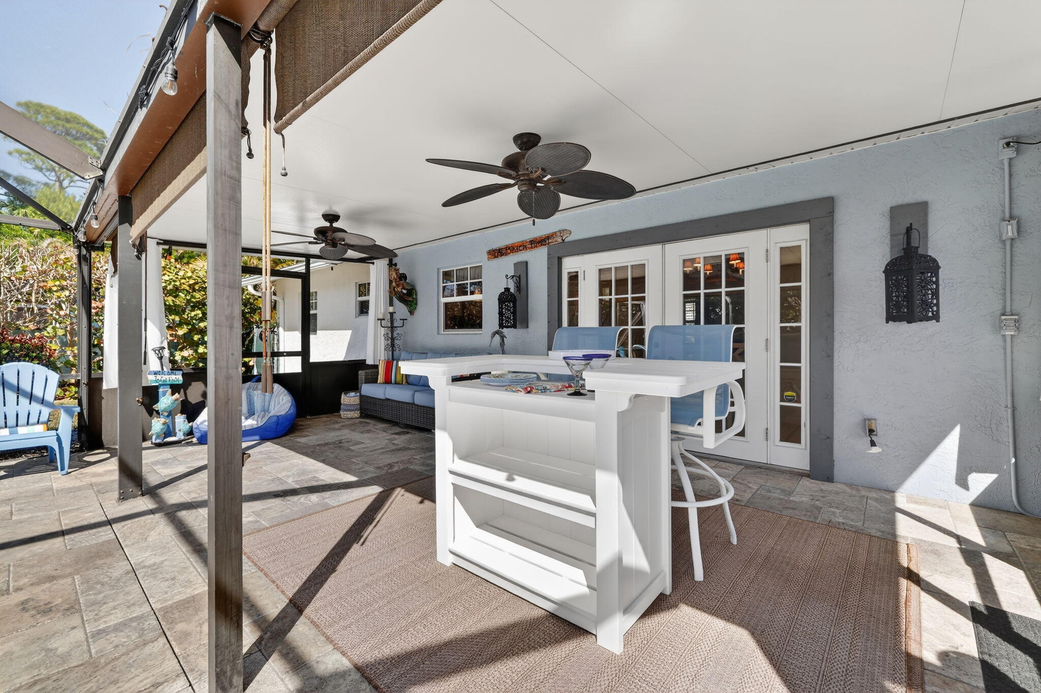 1252 East Madison Avenue Stuart, FL 34996 - Photo 27 of 43 a living room with furniture a chandelier and a dining table