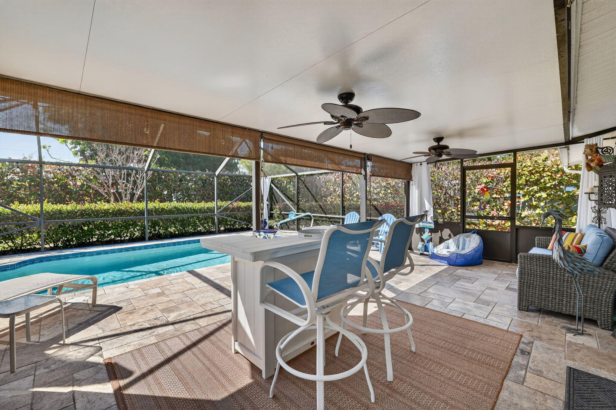1252 East Madison Avenue Stuart, FL 34996 - Photo 30 of 43 a view of a patio with couches plants dining table and chairs
