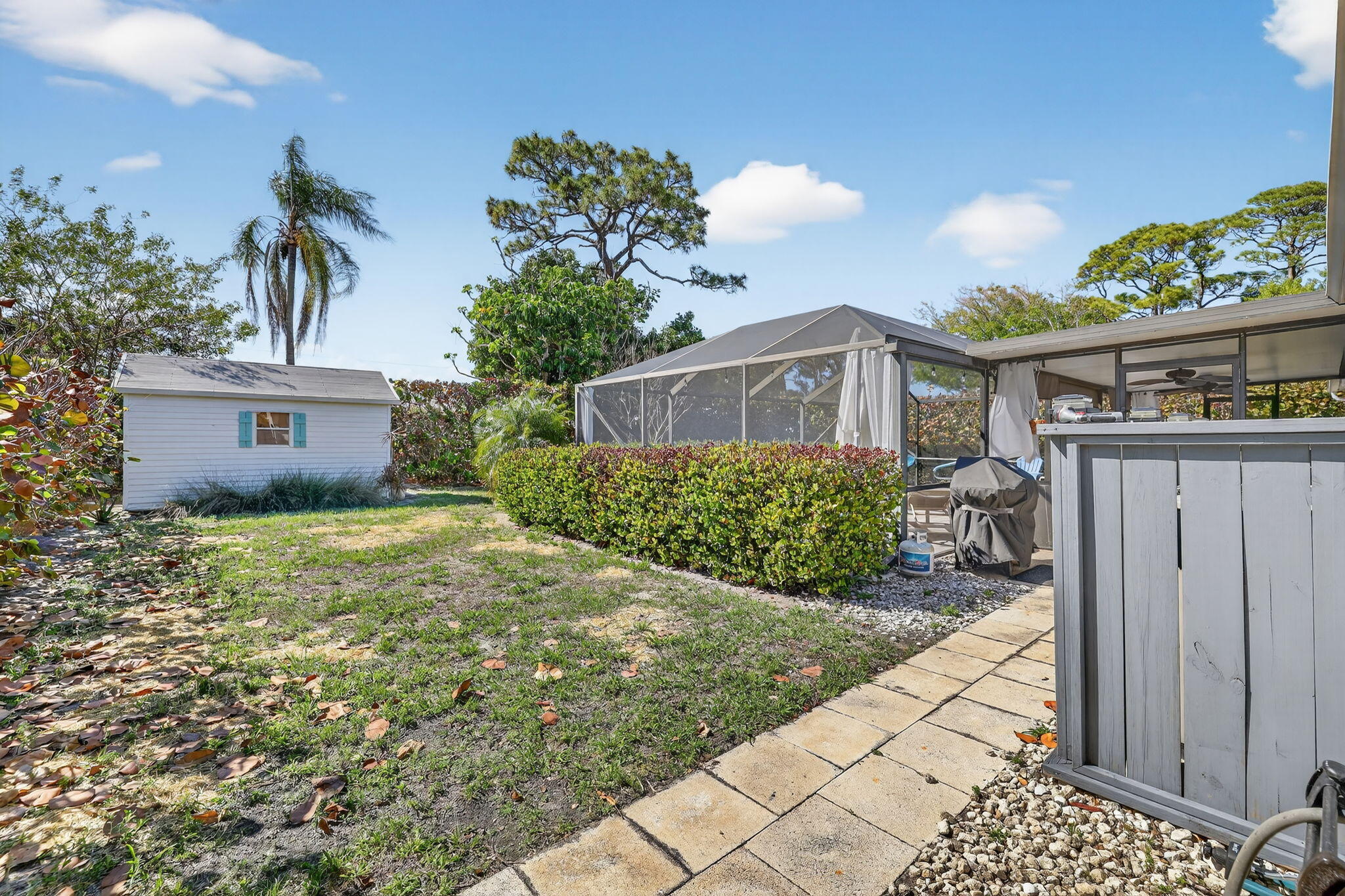 1252 East Madison Avenue Stuart, FL 34996 - Photo 38 of 43 a view of a house with a yard and potted plants