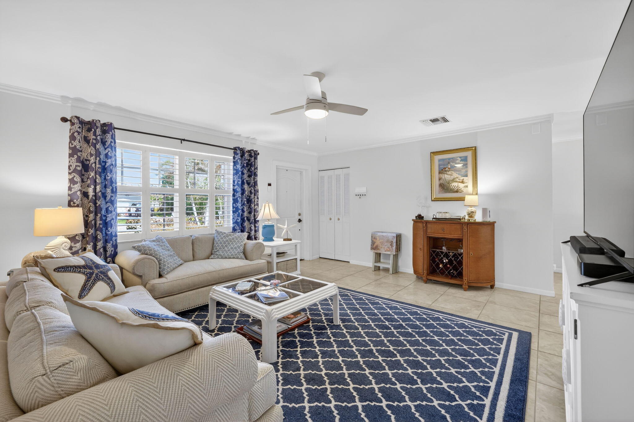 1252 East Madison Avenue Stuart, FL 34996 - Photo 7 of 43 a living room with furniture a rug and a fireplace