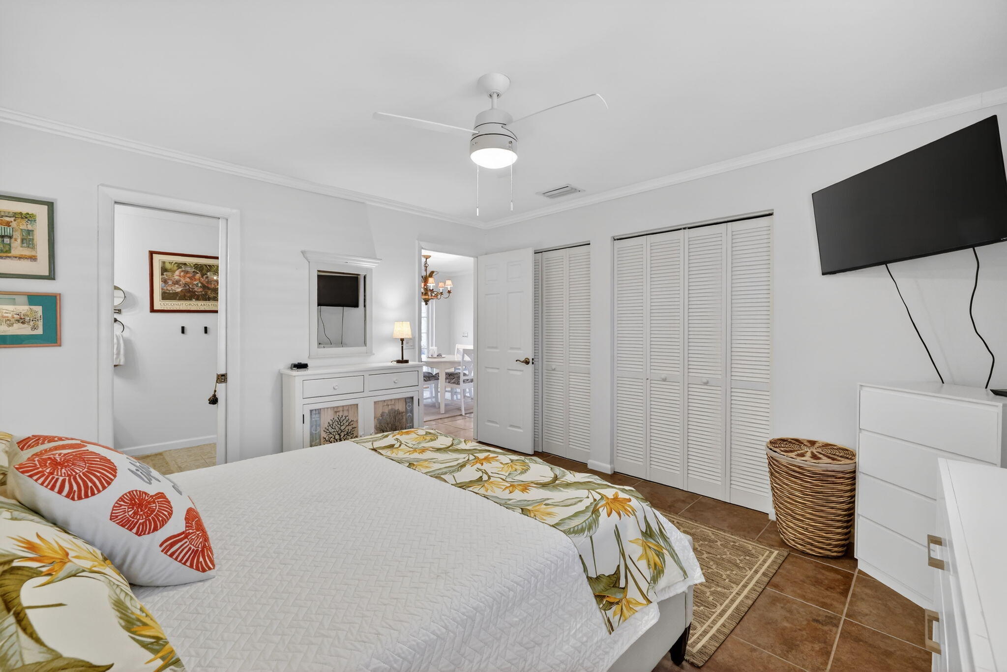 1252 East Madison Avenue Stuart, FL 34996 - Photo 10 of 43 a bedroom with a bed and a chandelier