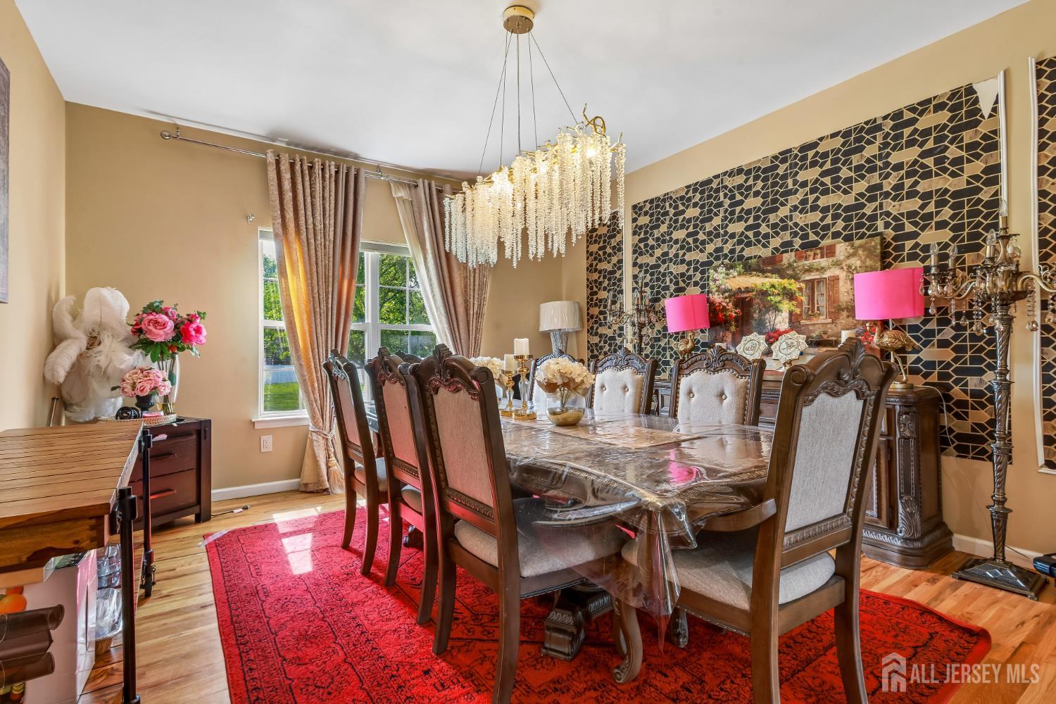 489 Plainfield Road Edison, NJ 08820 - Photo 7 of 39 a view of a dining room with furniture and a chandelier