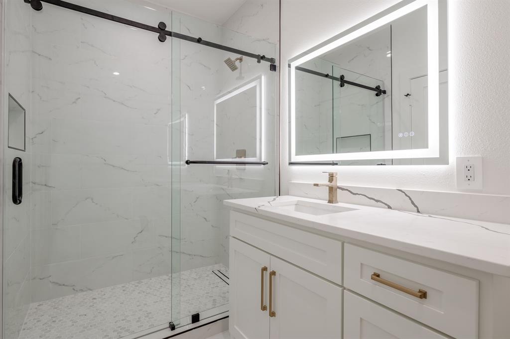 7503 Robin Road Dallas, TX 75209 - Photo 24 of 34 Bathroom with vanity and a marble finish shower