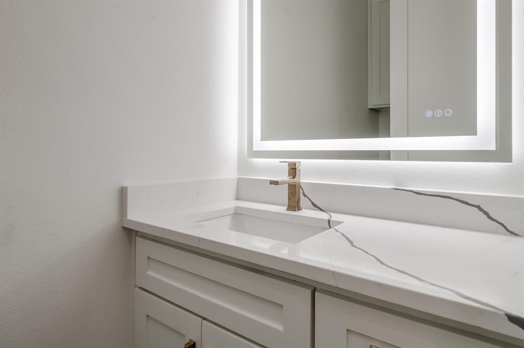 7503 Robin Road Dallas, TX 75209 - Photo 28 of 34 Bathroom featuring vanity and a textured wall
