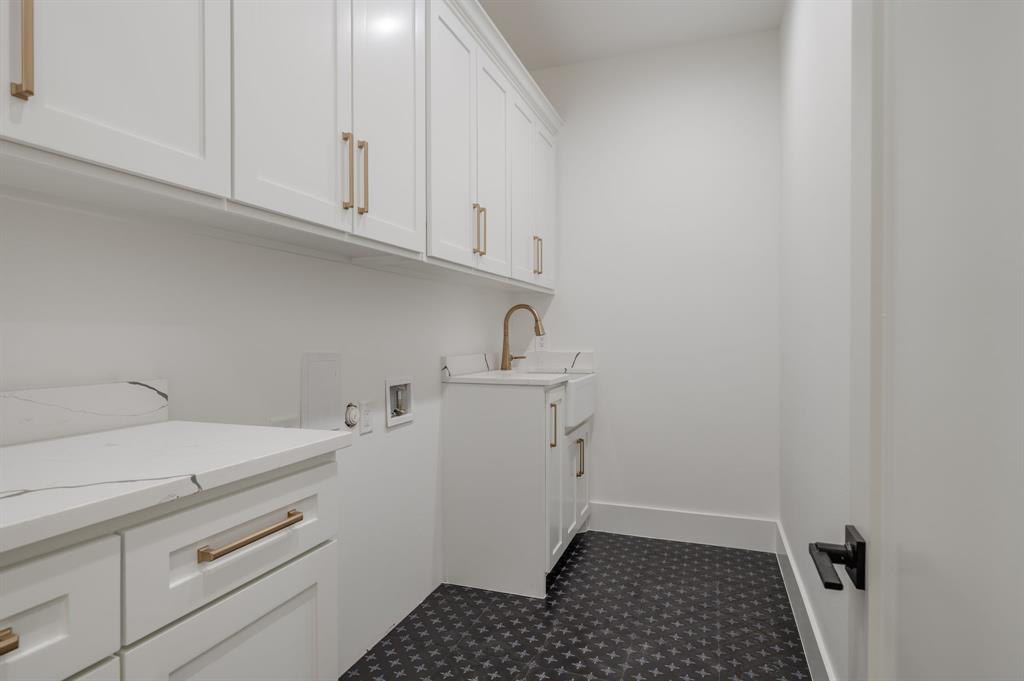 7503 Robin Road Dallas, TX 75209 - Photo 29 of 34 Laundry room with cabinet space and washer hookup