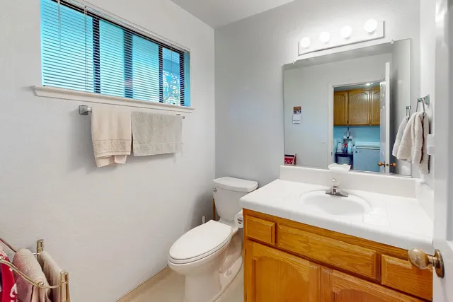 a view of a dining room with furniture a chandelier and window