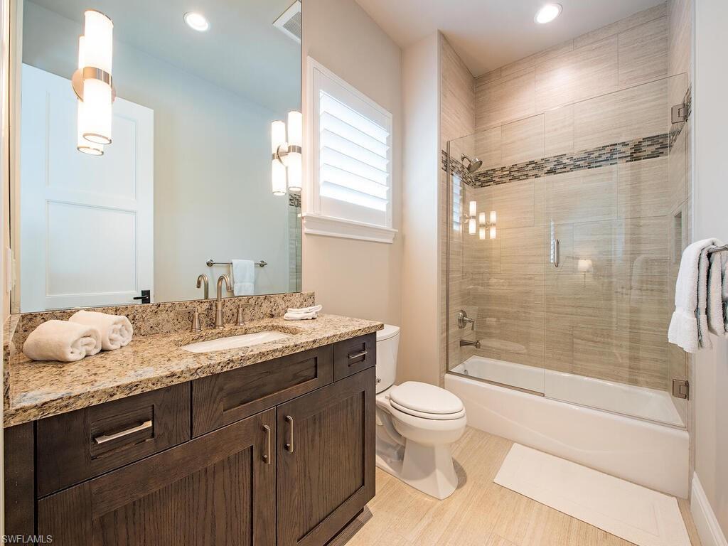 9200 Mercato Way Naples, FL 34108 - Photo 8 of 13 a bathroom with a granite countertop sink toilet and shower