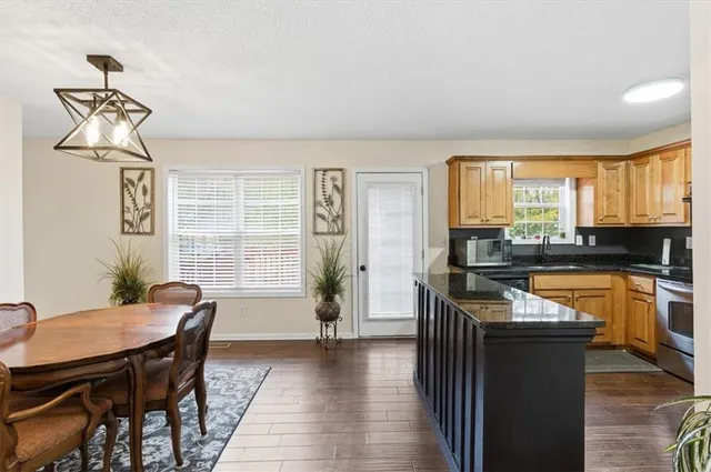 a kitchen with a table chairs stove and cabinets