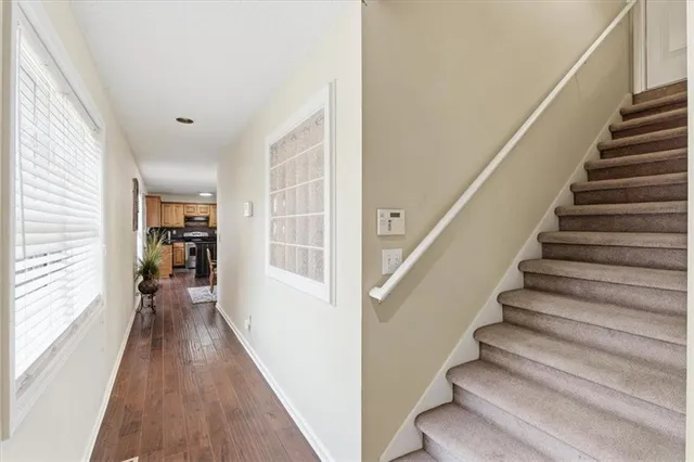 a view of entryway and hall with wooden floor