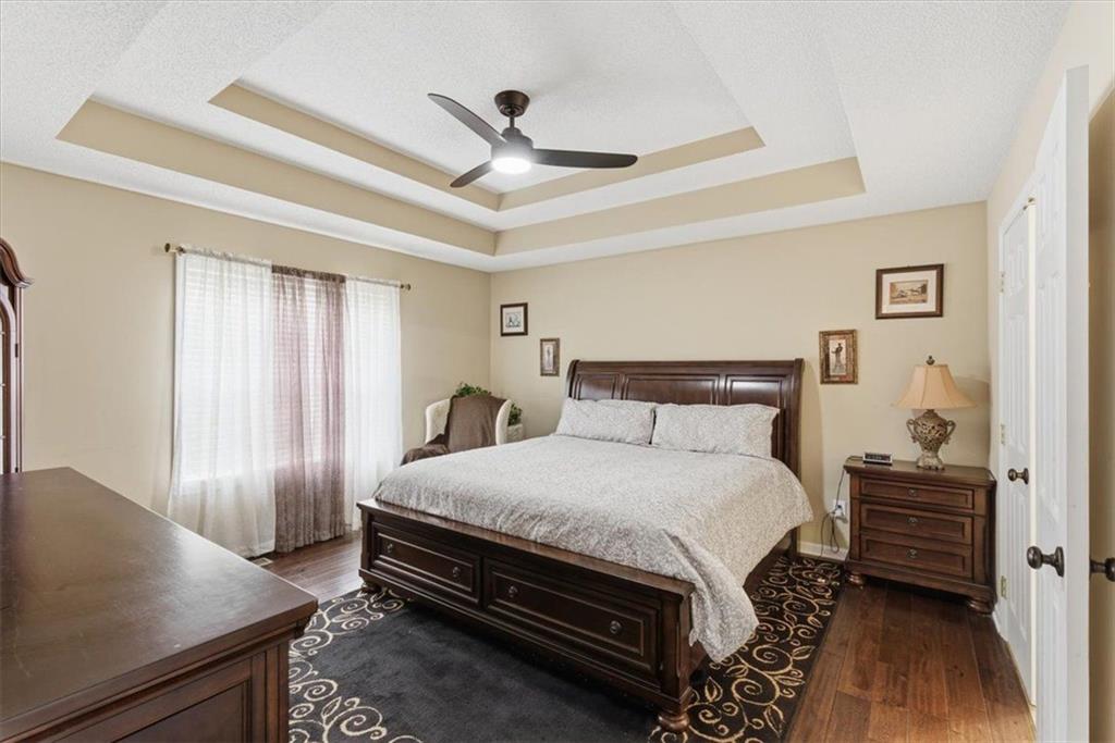 127 Prince Albert Court Southwest Calhoun, GA 30701 - Photo 21 of 50 a bedroom with a bed and a table