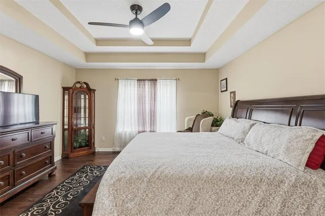 a bedroom with a large bed and a tv