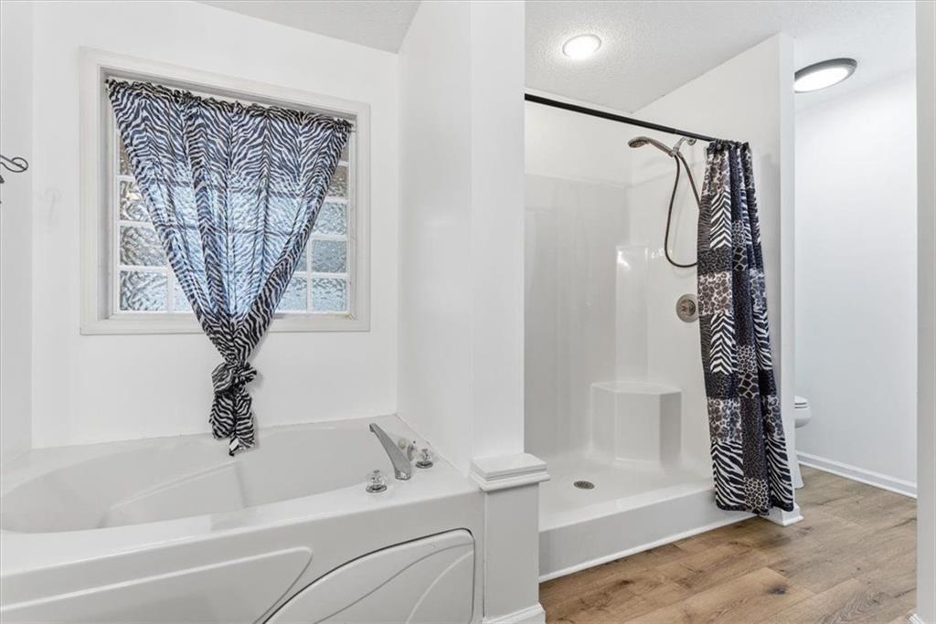 127 Prince Albert Court Southwest Calhoun, GA 30701 - Photo 26 of 50 a bathroom with a shower a toilet and a window