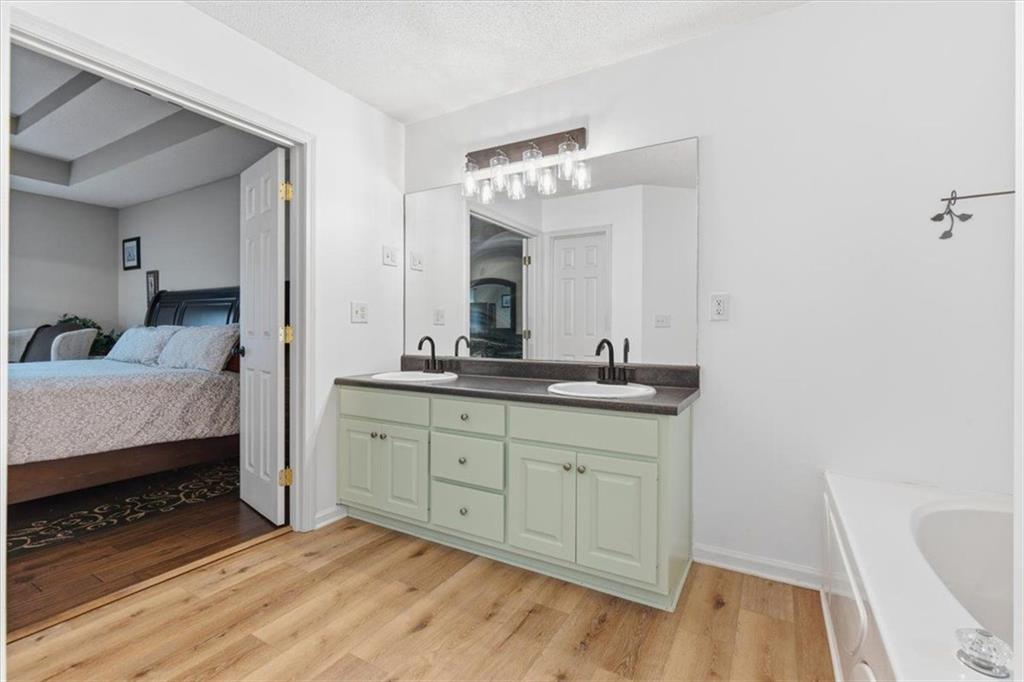 127 Prince Albert Court Southwest Calhoun, GA 30701 - Photo 27 of 50 a spacious bathroom with a granite countertop sink and a mirror
