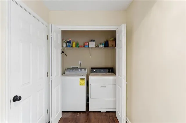 a storage room with wooden floor washer and dryer
