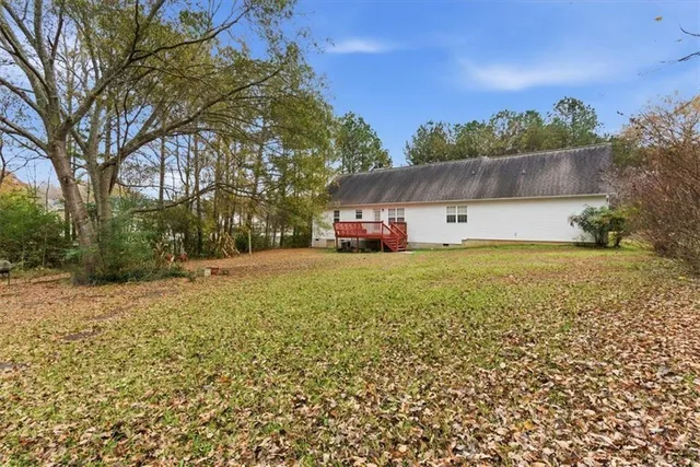 a view of a field with large trees