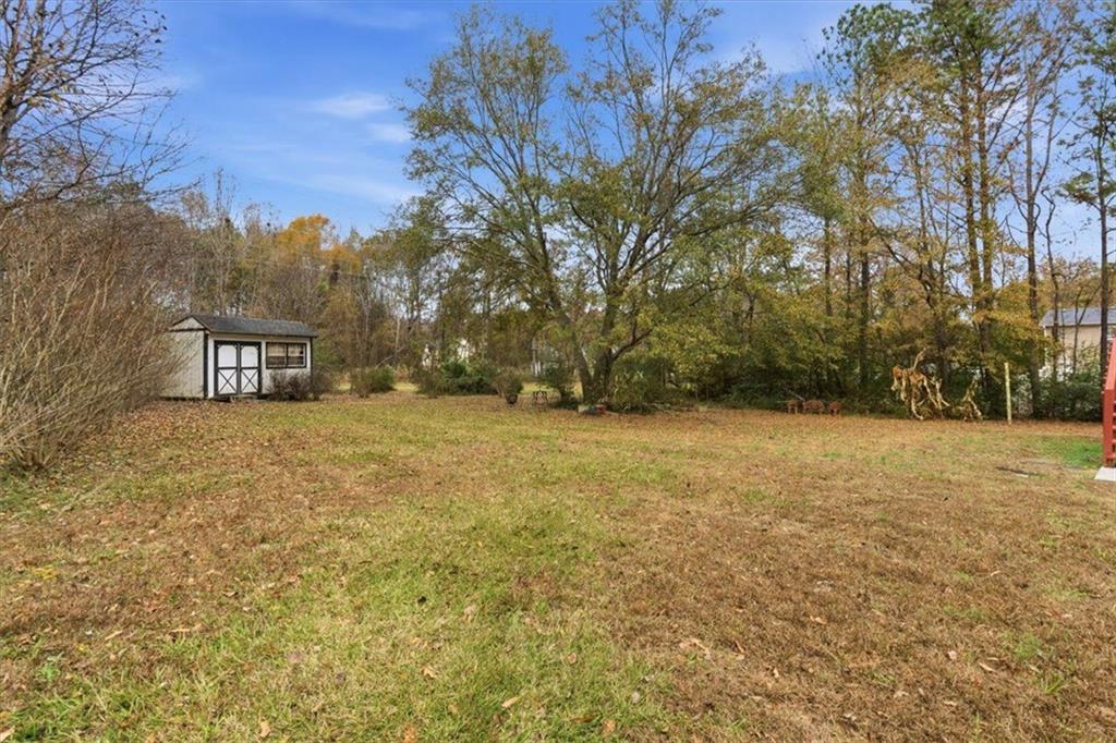 127 Prince Albert Court Southwest Calhoun, GA 30701 - Photo 40 of 50 a view of a field with a tree in the background