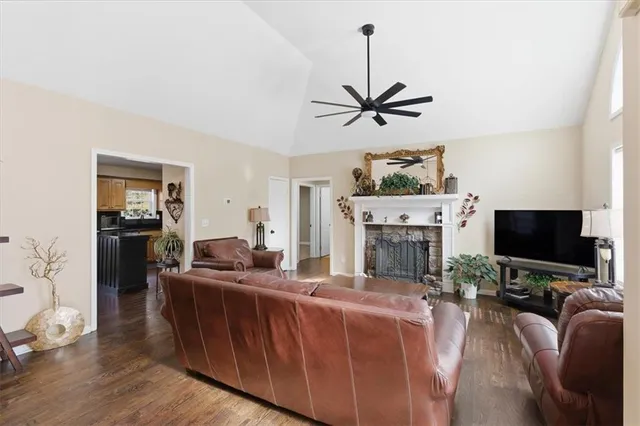 a living room with furniture a fireplace and a flat screen tv