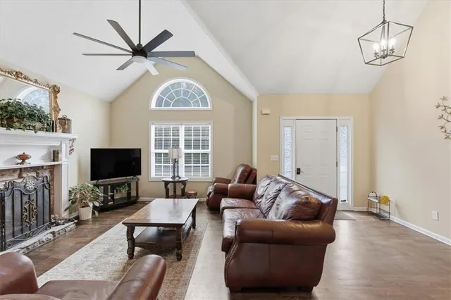 a living room with furniture a chandelier and a flat screen tv