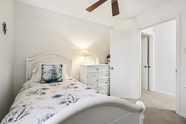 a bedroom with a bed and cabinet
