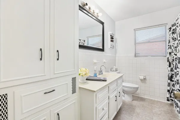 a bathroom with a toilet sink and mirror