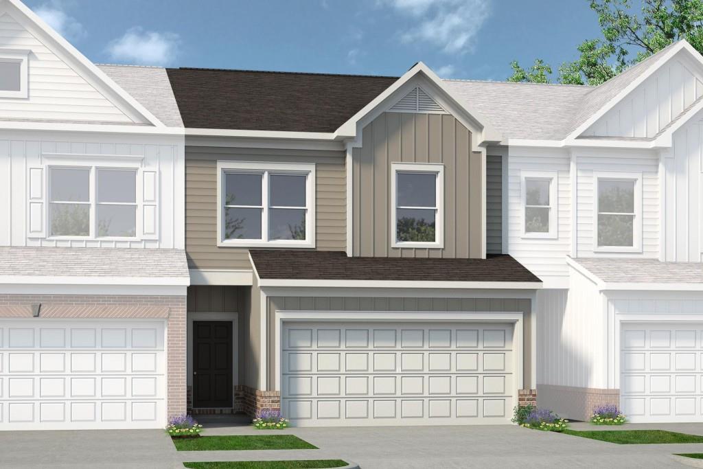 1194 Chastain Drive, Unit 1194 Sugar Hill, GA 30518 - Photo 1 of 1 a front view of a house with a yard and garage