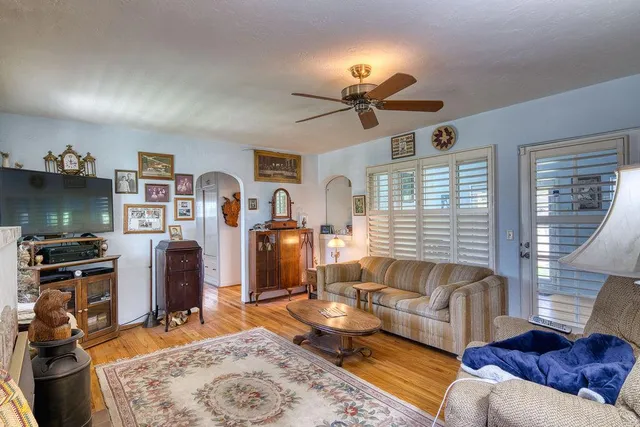 a living room with furniture a rug and a window