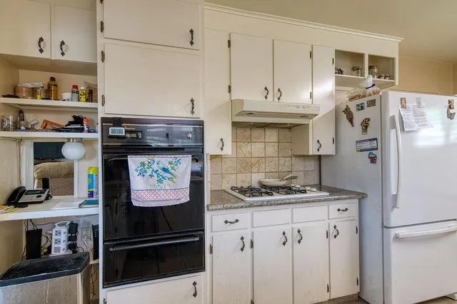a kitchen with stainless steel appliances a stove and a refrigerator