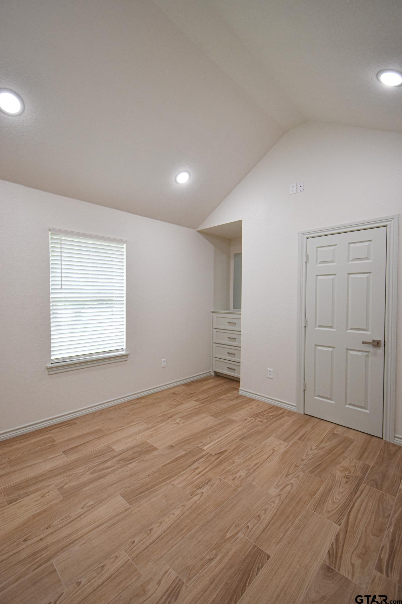 1417 East Earle Street Tyler, TX 75702 - Photo 19 of 31 a view of an empty room with wooden floor and window