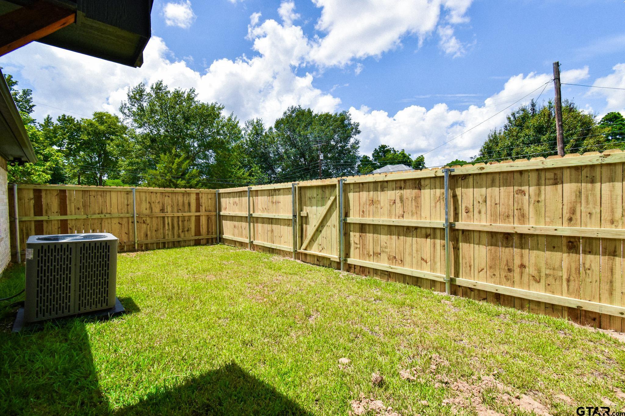 1417 East Earle Street Tyler, TX 75702 - Photo 29 of 31 a view of a backyard with wooden fence
