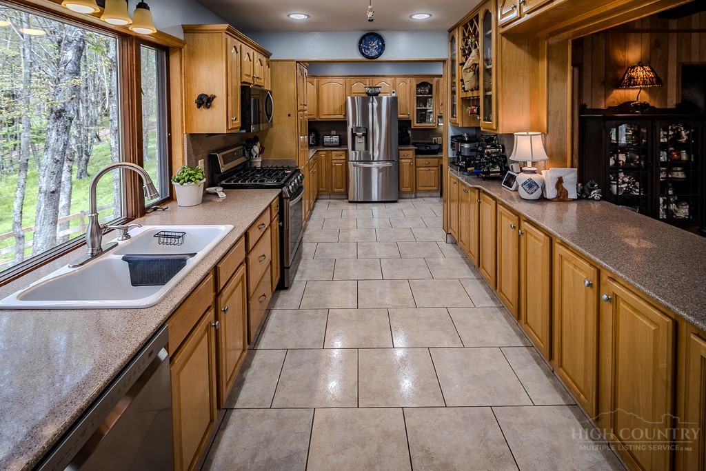 103-105 Upper Grouse Ridge Road Beech Mountain, NC 28604 - Photo 6 of 48 a kitchen with stainless steel appliances a sink stove and cabinets