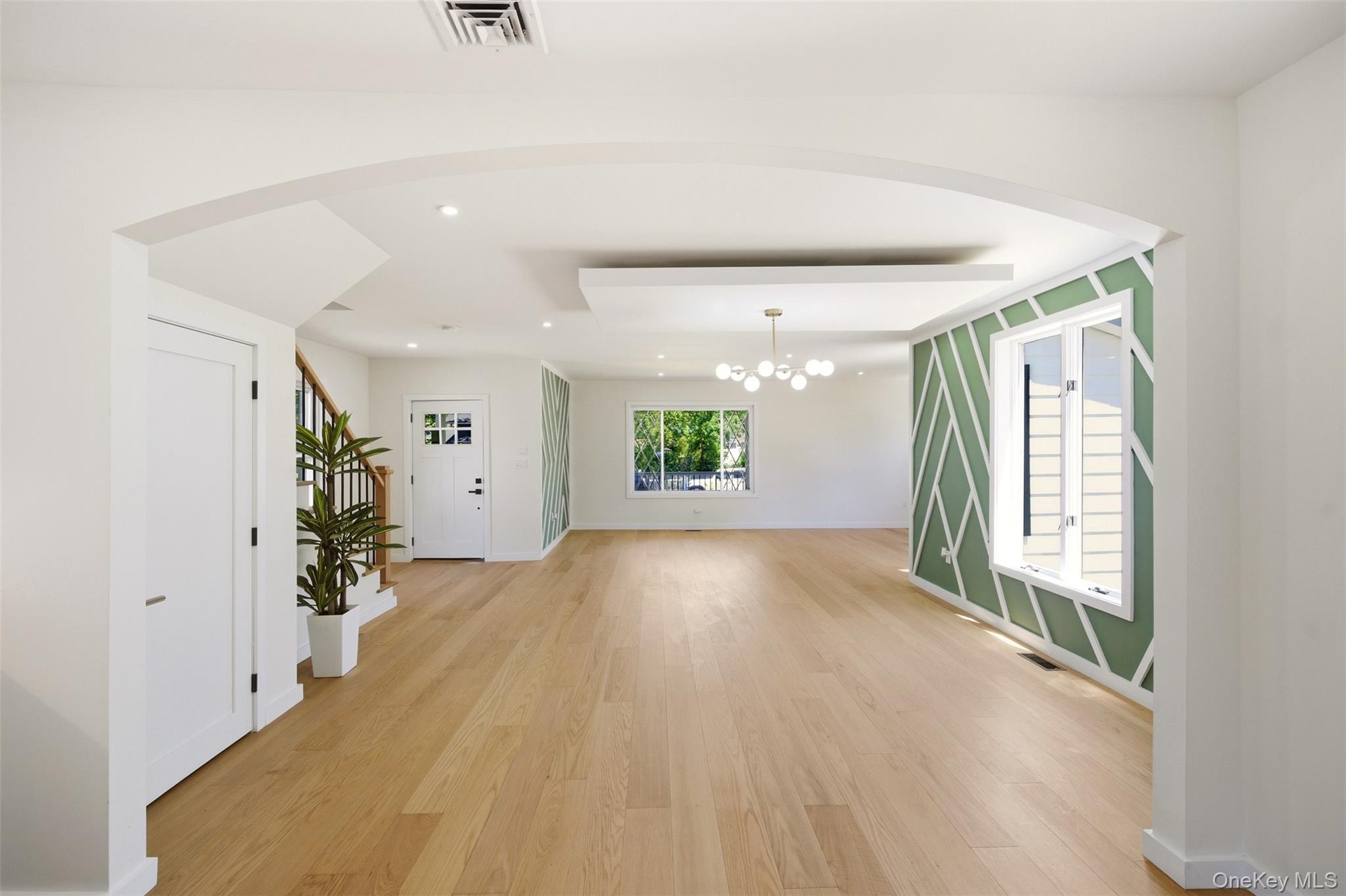 135 Whaley Street Freeport, NY 11520 - Photo 13 of 38 wooden floor in an empty room with a window