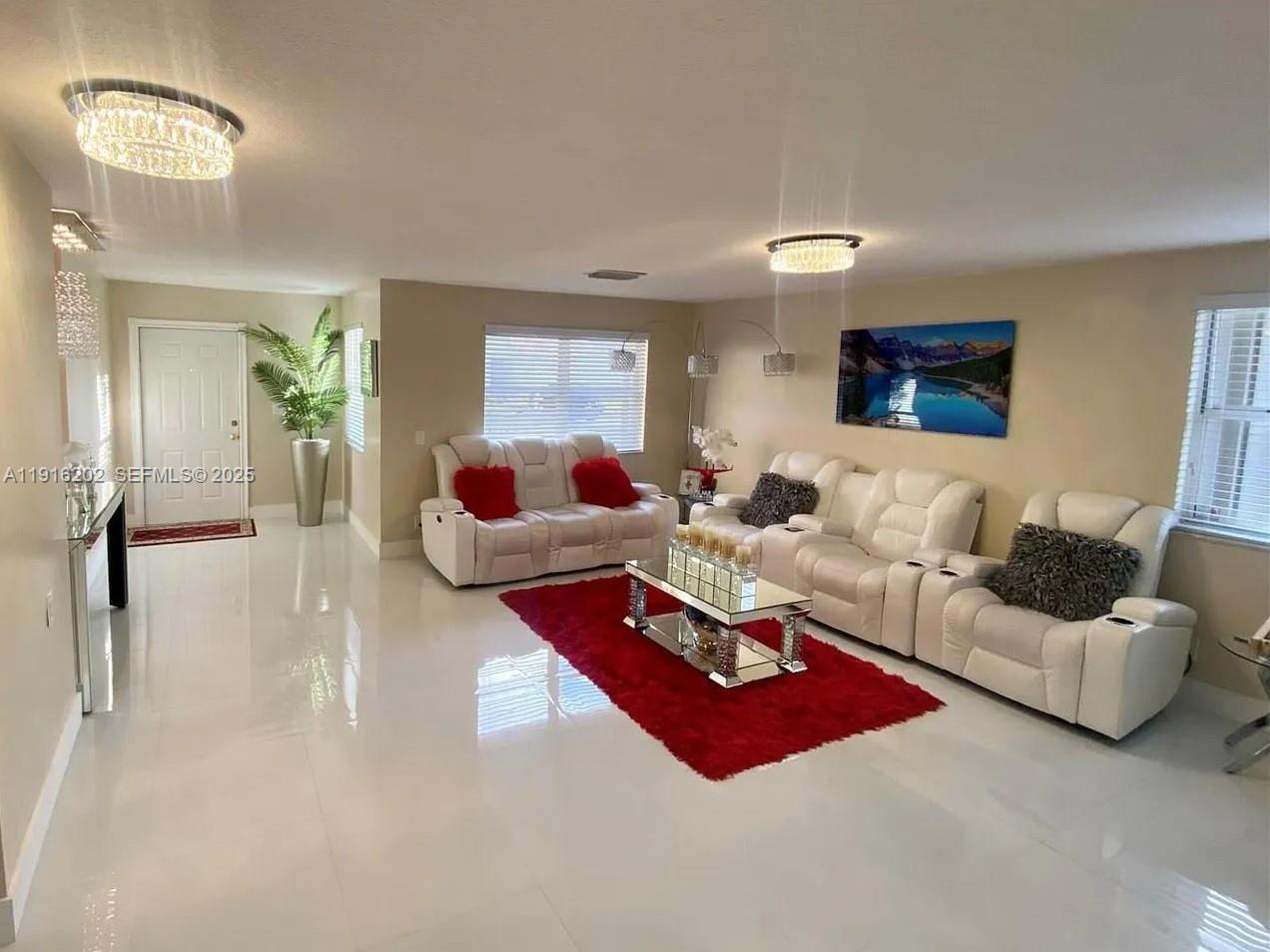 8568 Southwest 211th Terrace, Unit 8576 Cutler Bay, FL 33189 - Photo 11 of 12 a living room with furniture and a lamp