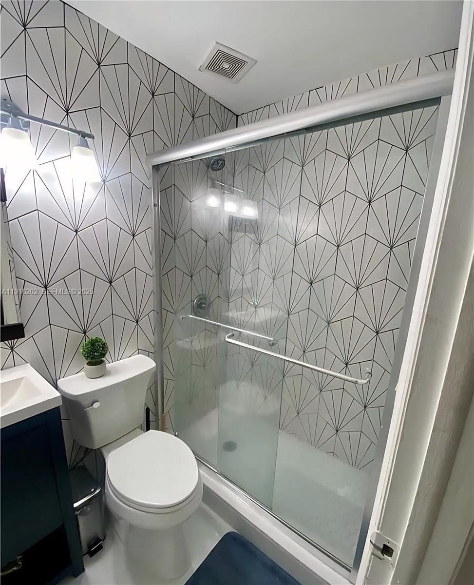 8568 Southwest 211th Terrace, Unit 8576 Cutler Bay, FL 33189 - Photo 12 of 12 a bathroom with a shower and a toilet