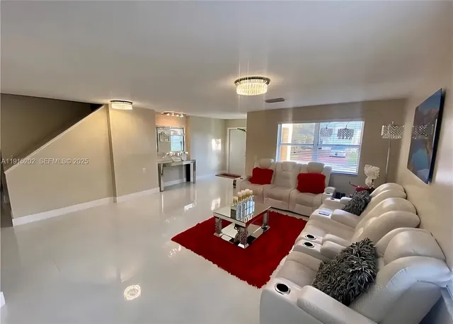 a living room with furniture rug and window