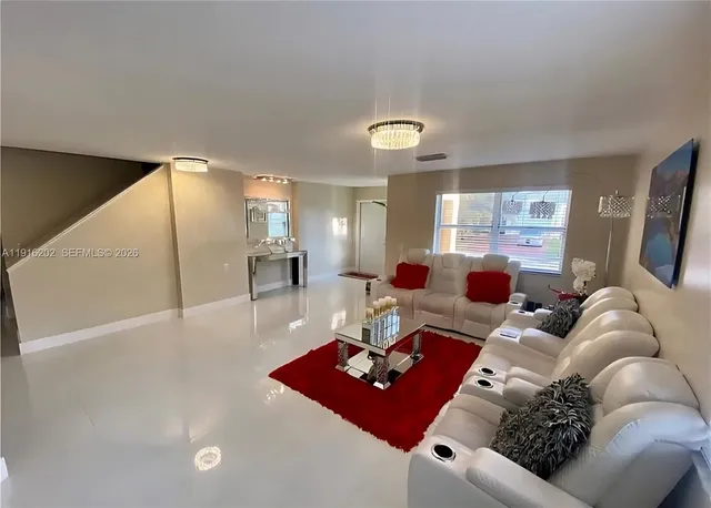 a living room with furniture rug and window